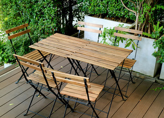 wooden chairs and wooden tables at the cozy outdoor terrace 