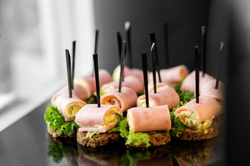 Delicious snacks with ham and lettuce. Concept for food, catering, restaurant, party.