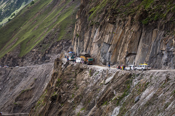 Trucks carrying goods are passing through Zojila Pass, India.