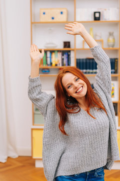 Pretty woman with red hair waving hands