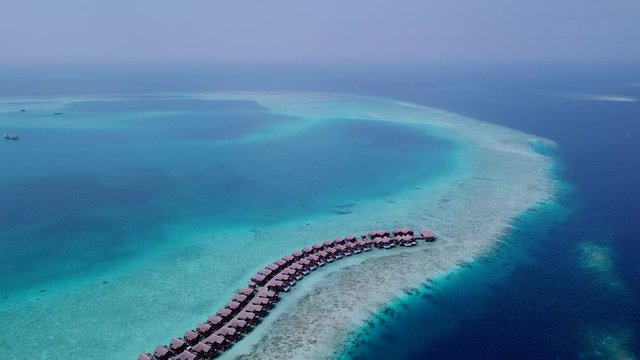 Quadcopter aerial shoot of luxury resort bungalows and ships