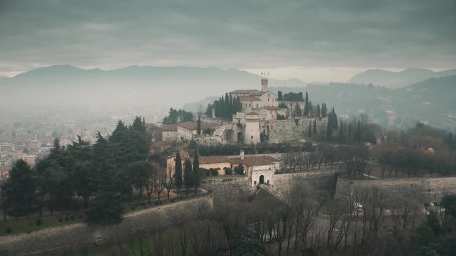 Aerial shot of Castle of Brescia on a foggy day, Italy
