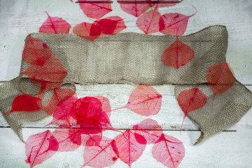 festive texture with leaves, feathers and jute fabric ribbon