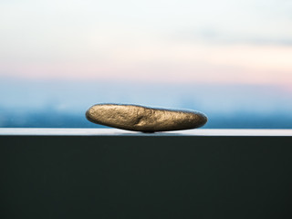 A gold ore is placed next to the window under the morning light.