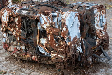 Abandoned rusty pressed piece of car