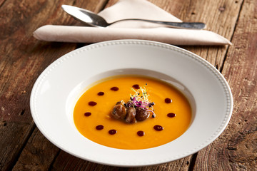 Sweet potato cream soup with ginger, roasted chestnuts and pumpkin seed oil