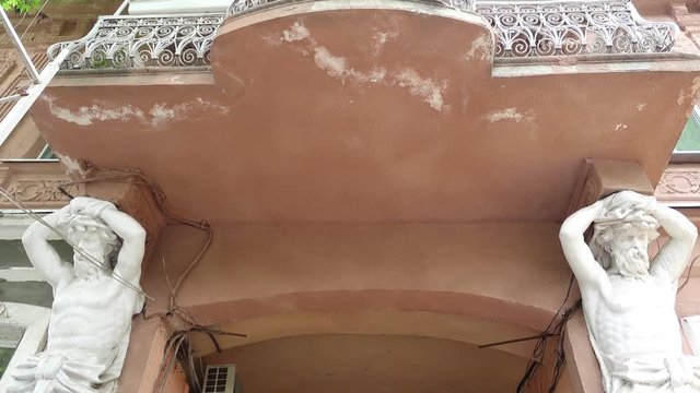 Kherson, Ukraine - 14th of June 2017: 4K Two atlantes holding balcony