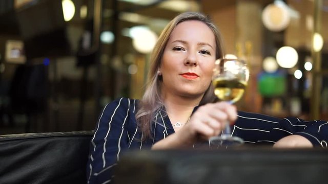 girl sitting in a cafe with wine