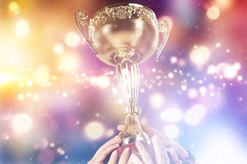 Hands holding a champion golden trophy on white background