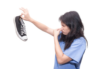 young asian woman holds up smelly stinky sneaker shoe