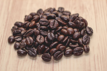 Roasted coffee beans on wood background