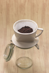 Drip coffee with paper filter tool on wood background