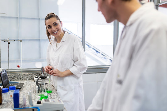 Young man and woman working on a laboratory of factory