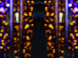 Grid multi colored bokeh on a dark background. Abstract blurred image.