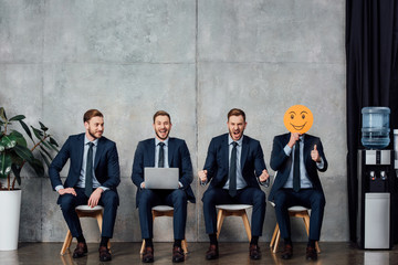 collage of cloned businessman sitting in waiting hall and showing various emotions