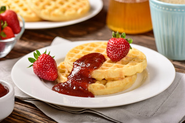Waffles and jam on breakfast table