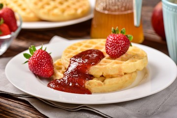 Waffles and jam on breakfast table