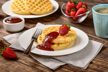 Waffles and jam on breakfast table