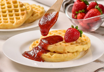 Waffles and jam on breakfast table
