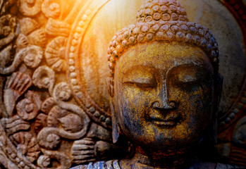 Fototapeta na wymiar Rock Buddha statue with sunlight used for amulets of Buddhism religion. Buddhism is popular region in China Japan and south east Asia.copy space concept.