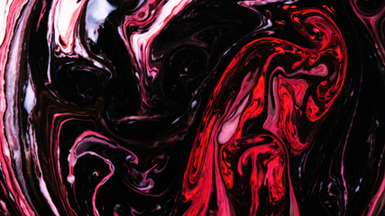 Pink and black psychedelic paints are mixed into abstract patterns in white liquid