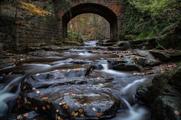Water on stones under bridge
