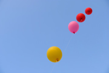 Colorful flying balloon with blue sky. Freedom concept.