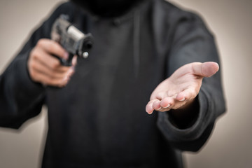 Gun and money in a hands. Bank robbery, Man carrying a gun to rob the money. To threaten with the gun man