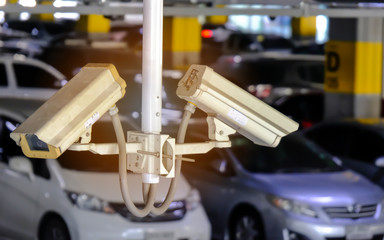 2 CCTV or Close Circuit Television are monitor and record cars in parking lot of shopping mall to prevent robbery and security.