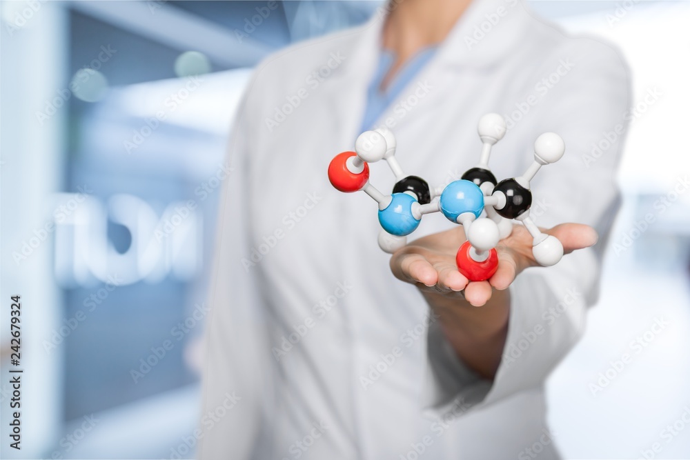 Wall mural close up of molecular structure model in hand on background