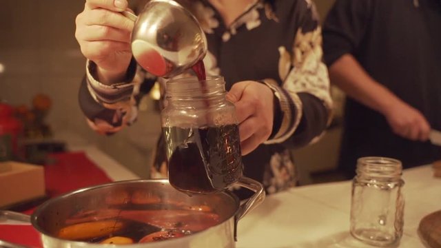 Mulled Wine Is Poured Into Mugs On The Table Among Christmas Decorations, Slow Motion, Camera Movement