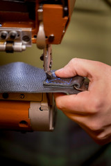 Vertical Shot of Sewing a Complete Box Stitch on Black Leather