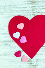 Valentines Day Card Background with Fabric Hearts over White Wooden Background. Selective focus.