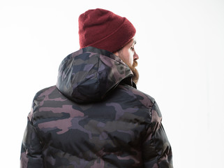 Winter stylish menswear. Man stand warm camouflage pattern jacket parka with hood isolated on white background. Hipster winter fashion. Guy wear hat and black winter jacket. Comfortable winter outfit © be free