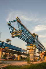 Fototapeta na wymiar Construction crane and girder of bridge construction site.New expressway construction site and equipment.