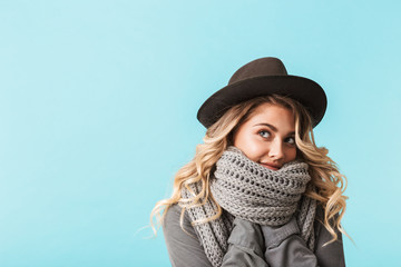 Pretty young blonde woman wearing hat and scarf