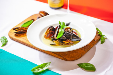 Cooked mussels on white plate. Close up