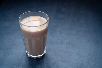 Coffee drink latte, coffee latte in glass on a dark gray stone table, copy space.