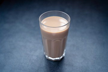 Coffee drink latte, coffee latte in glass on a dark gray stone table, copy space.