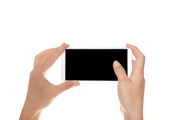 Mock-up of modern smartphone in the hands of a girl. Phone in horizontal position with a blank screen and isolated on white