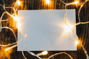 paper sheet surrounded by fairy lights and with copyspace to add your text