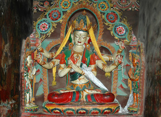 White Tibetan deity statue with six arms in a monastery in Tibet