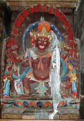 Statue of a Tibetan female deity of brown color in a monastery in Tibet