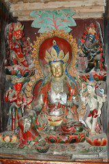Ancient sacred statue of a deity with a silvery body in a Tibetan monastery