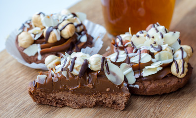 nougat (caramel) filling cakes (tartlets) with nuts (whole hazelnuts, almond)