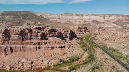 Fototapeta premium Road crossin beautiful canyon in summer season, aerial view