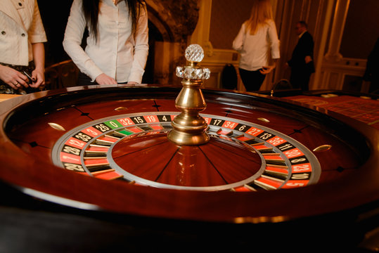 Roulette gambling table in casino. Players concept.