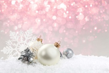 Fototapeta na wymiar Silver christmas balls over snow isolated on white