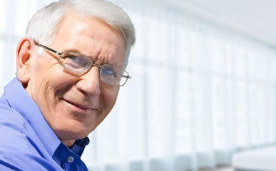 Happy senior man in blue shirt