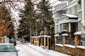 Obraz premium Street of town covered with snow. Belgrade is a largest town and capital of Serbia. Dedinje is a rich part of town.